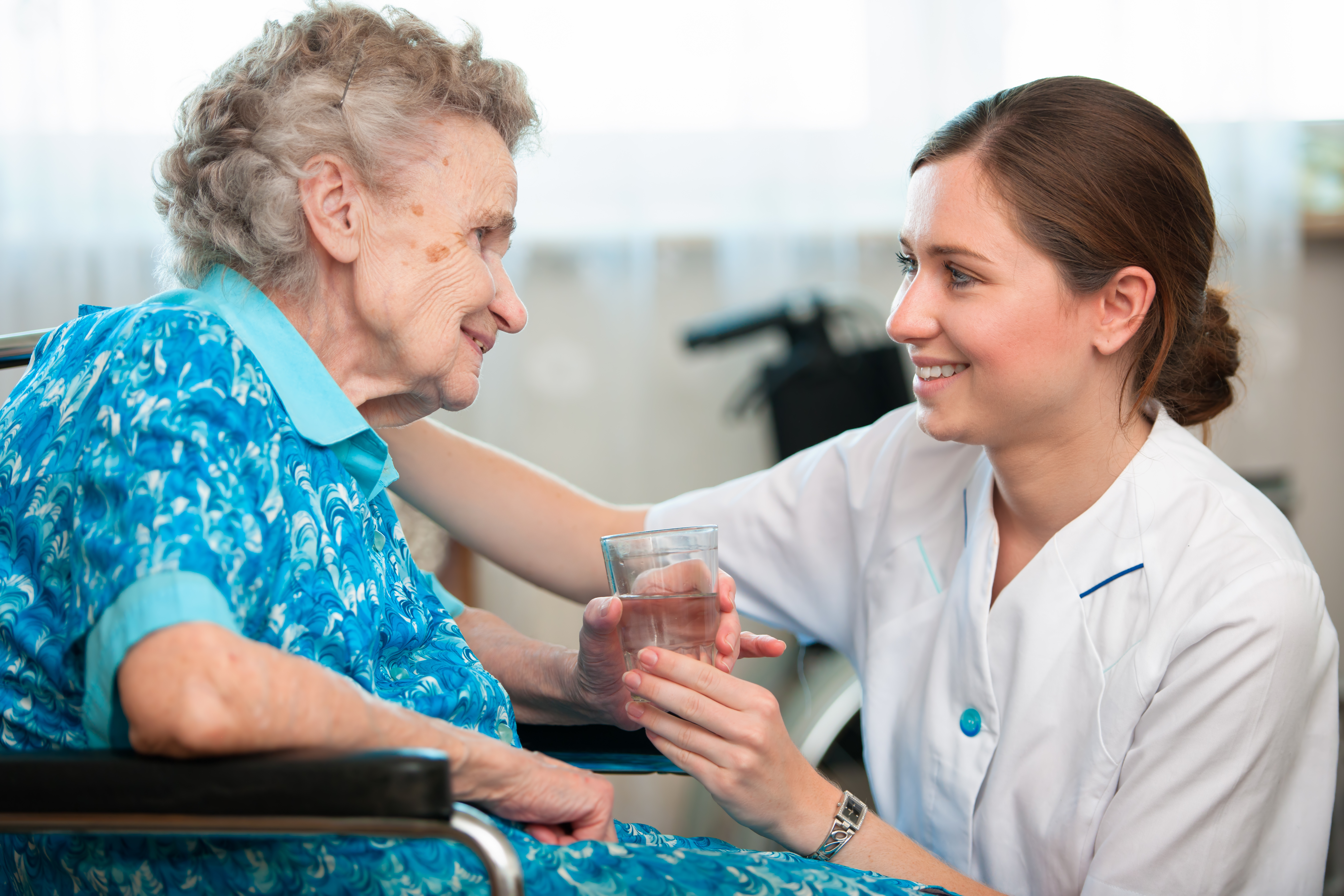 Women assisting elderly women - Shutterstock