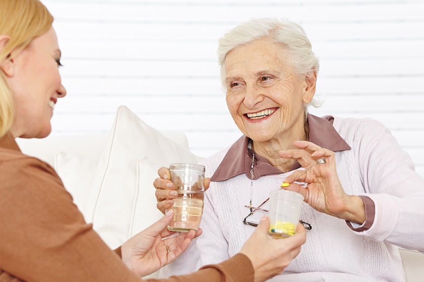 nurse assisting client with medication  Shutterstock